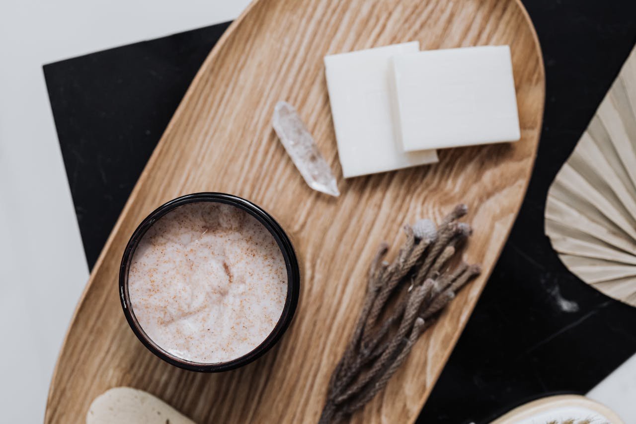 Flat lay of eco-friendly beauty products on a wooden tray, featuring natural ingredients and organic cosmetics.