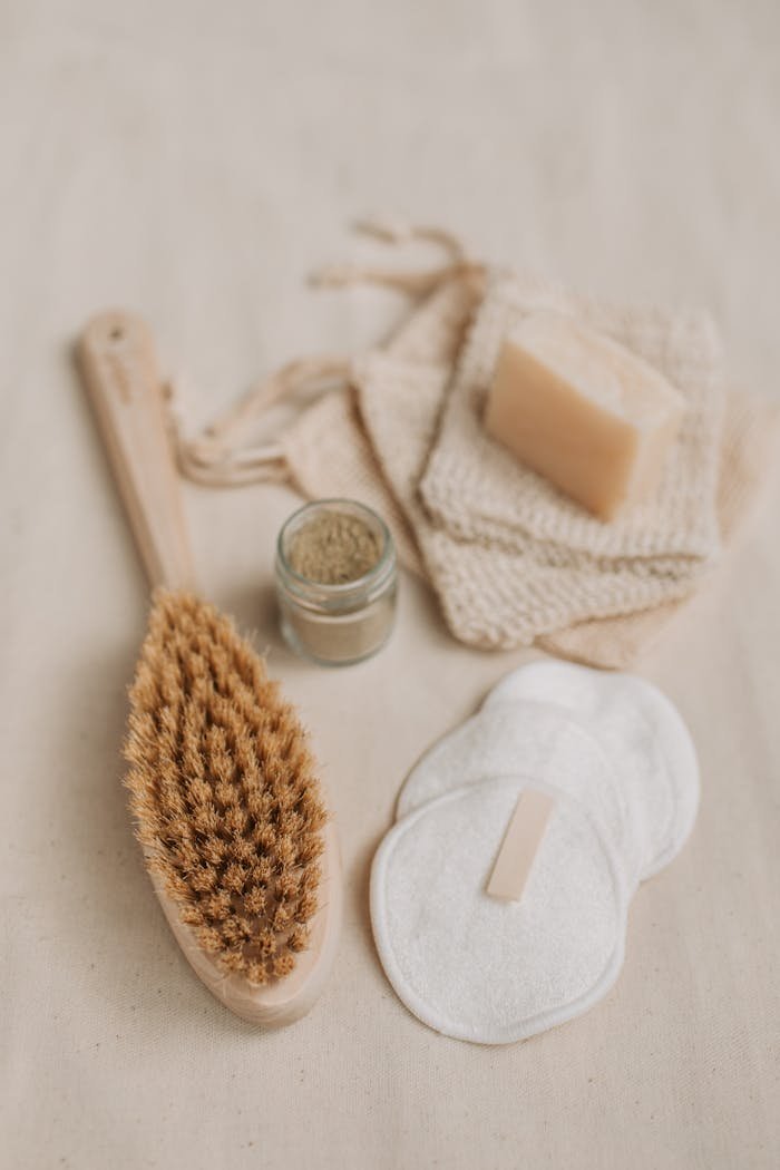 A collection of sustainable personal care items including a brush, bar soap, and a jar, emphasizing zero waste living.